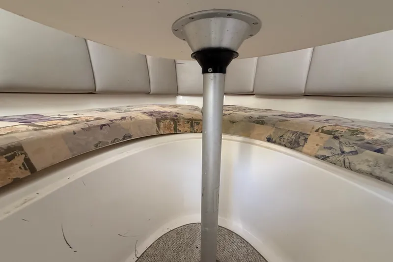 Slide: The Image of Interior cabin of 2002 Century 2900 Walk-Around boat with cushioned seating. - 95