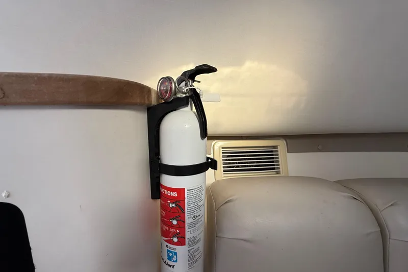 Slide: The Image of Fire extinguisher mounted inside a 2002 Century 2900 Walk-Around boat cabin. - 96