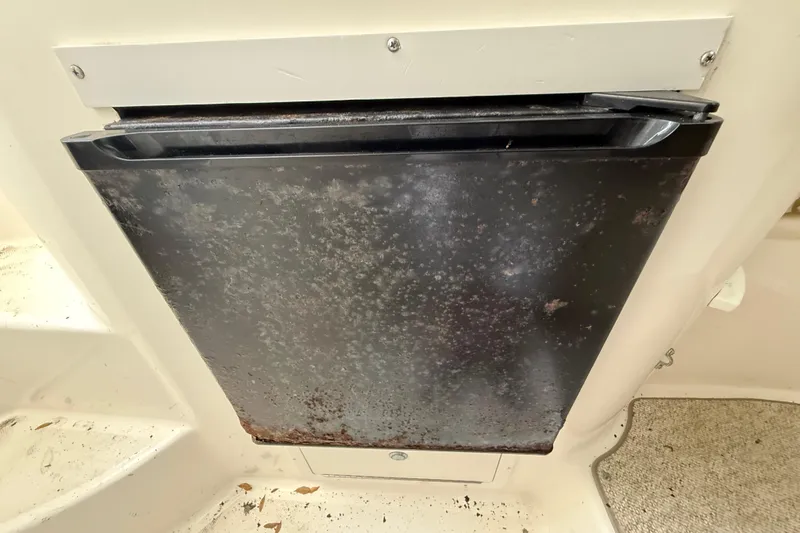 Slide: The Image of Rusty metal panel on a 2002 Century 2900 Walk-Around boat interior. - 99