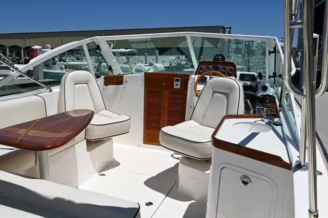 Slide: The Image of 2013 Hunt Yachts Harrier 25 interior with white seating and wooden accents. - 11