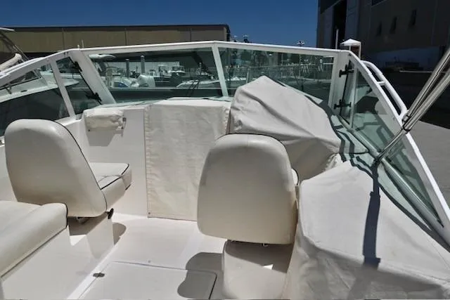 Slide: The Image of 2013 Hunt Yachts Harrier 25 interior with white seating and protective covers. - 14