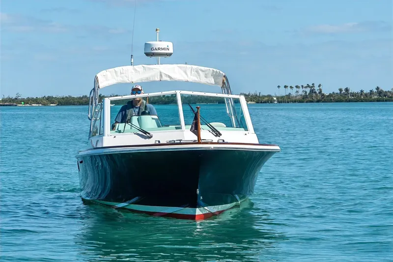Slide: The Image of 2013 Hunt Yachts Harrier 25 cruising on clear blue water under a sunny sky. - 4