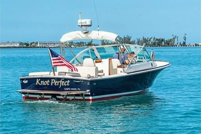 Slide: The Image of 2013 Hunt Yachts Harrier 25 named "Knot Perfect" cruising in clear blue waters. - 6