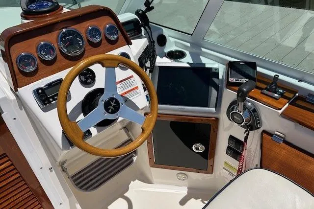 Slide: The Image of Cockpit of 2013 Hunt Yachts Harrier 25 with wooden steering wheel and navigation instruments. - 8