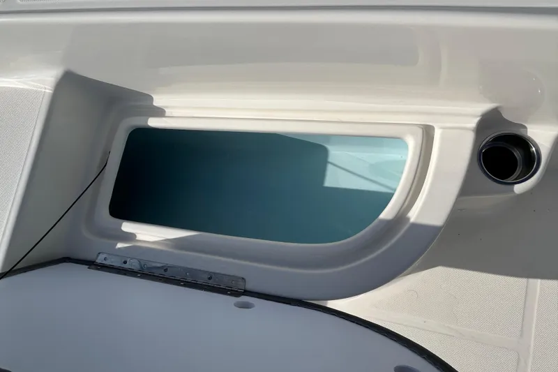 Slide: The Image of Storage compartment on a 2026 Sundance DX22 boat, featuring sleek design and functionality. - 13