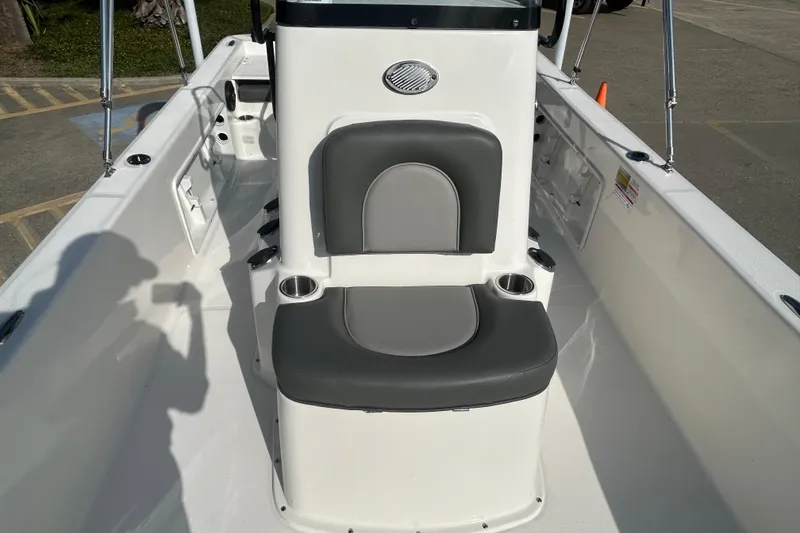 Slide: The Image of 2026 Sundance DX22 boat interior with gray seating and cup holders. - 15