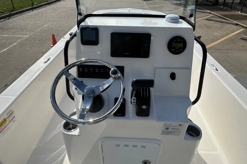 Slide: The Image of 2026 Sundance DX22 boat console with steering wheel and navigation controls. - 16