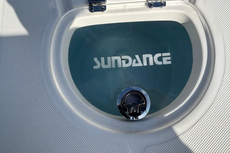 Slide: The Image of 2026 Sundance DX22 boat hatch with logo and latch detail. - 19