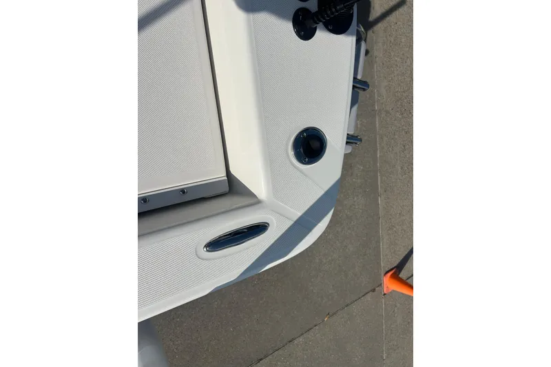 Slide: The Image of 2026 Sundance DX22 boat deck detail with cleats and textured surface. - 20