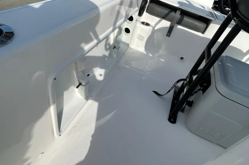 Slide: The Image of 2026 Sundance DX22 boat interior with seating and storage compartments. - 23