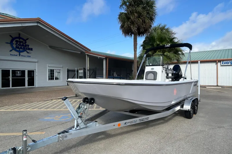 Slide: The Image of 2026 Sundance DX22 boat on trailer at Gulf Coast Marine dealership. - 6
