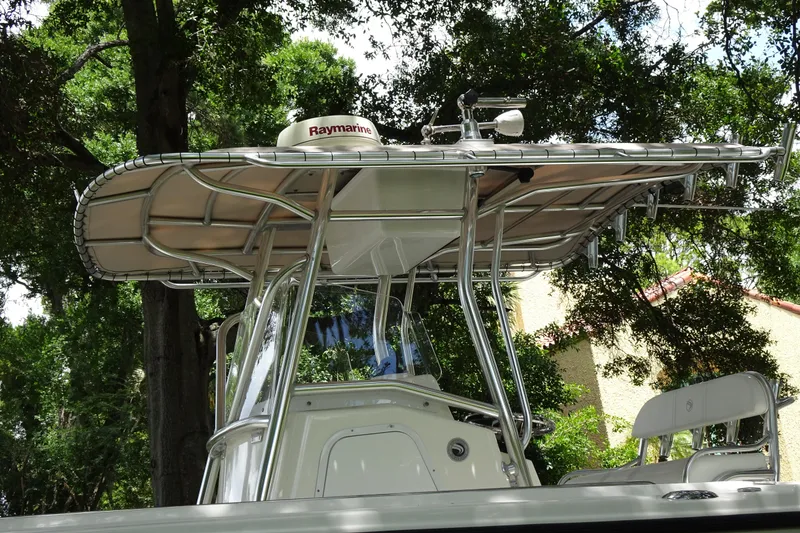 Slide: The Image of 2006 Edgewater 265CC boat with Raymarine equipment, surrounded by lush trees. - 10