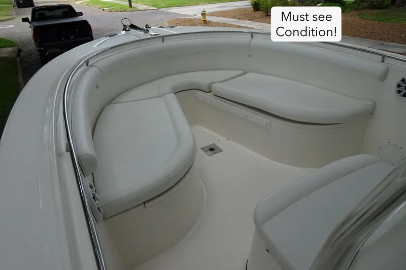 Slide: The Image of 2006 Edgewater 265CC boat interior with white seating, showcasing excellent condition. - 11
