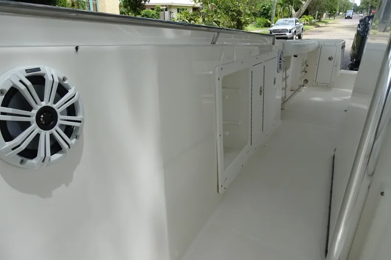 Slide: The Image of 2006 Edgewater 265CC boat interior with speaker and storage compartments. - 14