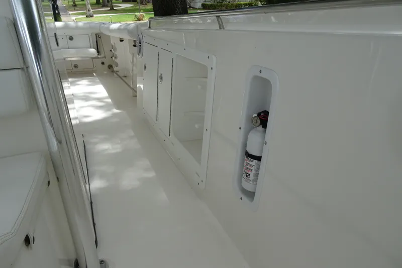 Slide: The Image of 2006 Edgewater 265CC boat interior with storage compartments and fire extinguisher. - 15