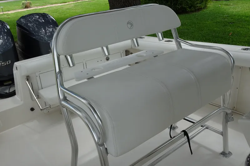 Slide: The Image of 2006 Edgewater 265CC boat interior with dual engines and cushioned seating. - 16