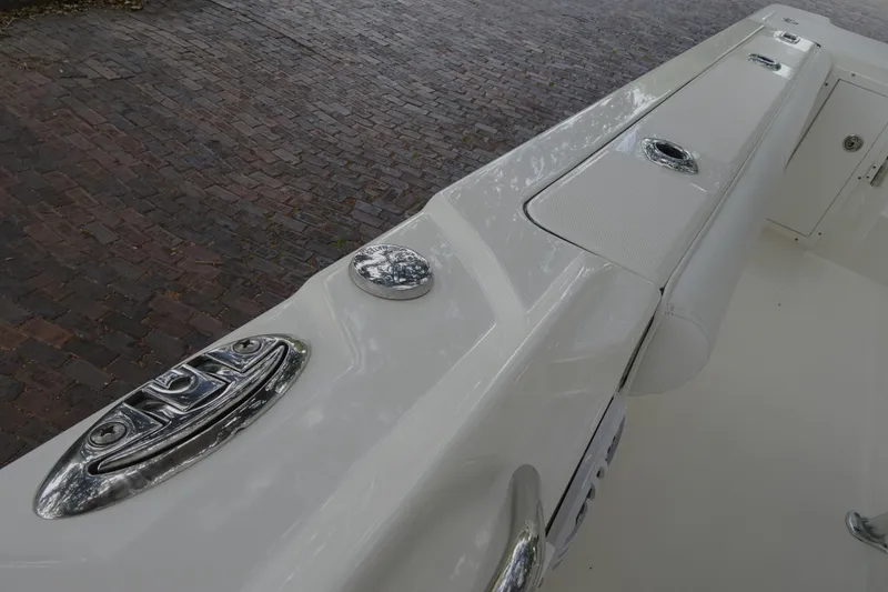 Slide: The Image of 2006 Edgewater 265CC boat deck with chrome fittings and padded seating. - 17