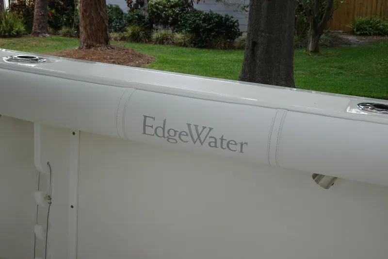 Slide: The Image of 2006 Edgewater 265CC boat interior with logo, surrounded by lush greenery. - 18