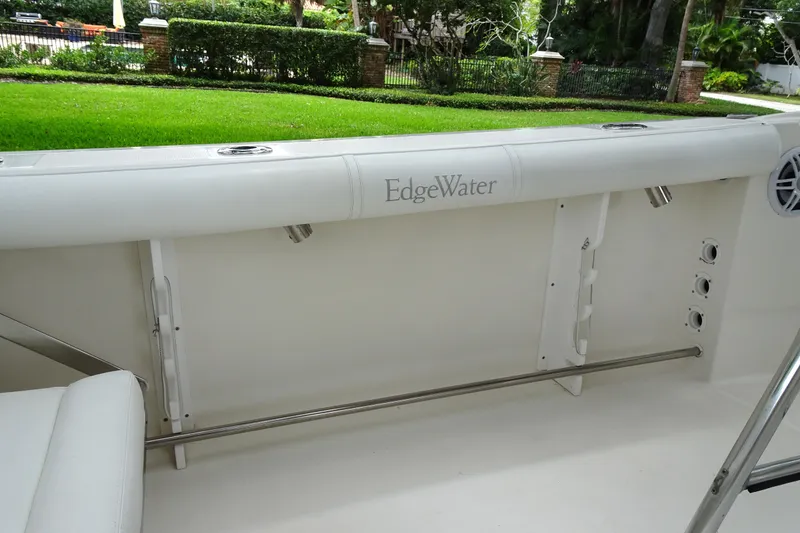 Slide: The Image of 2006 Edgewater 265CC boat interior with white seating and stainless steel fittings. - 19