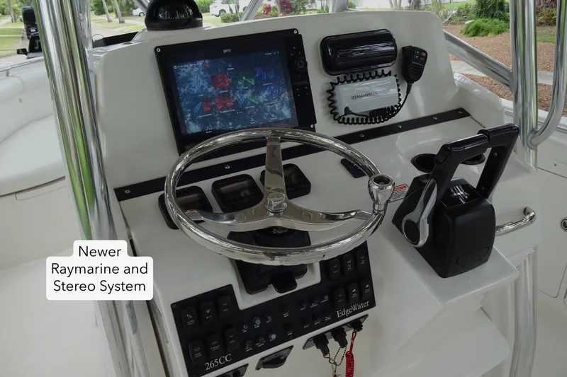 Slide: The Image of 2006 Edgewater 265CC boat dashboard with newer Raymarine and stereo system. - 20