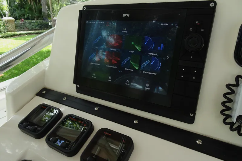 Slide: The Image of Dashboard of a 2006 Edgewater 265CC boat with navigation and control displays. - 21
