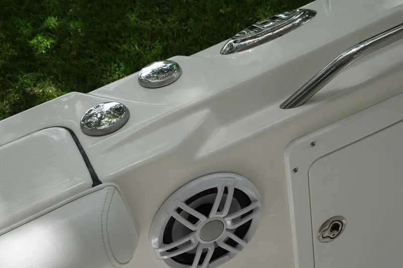 Slide: The Image of 2006 Edgewater 265CC boat interior with speaker, chrome fixtures, and white upholstery. - 23