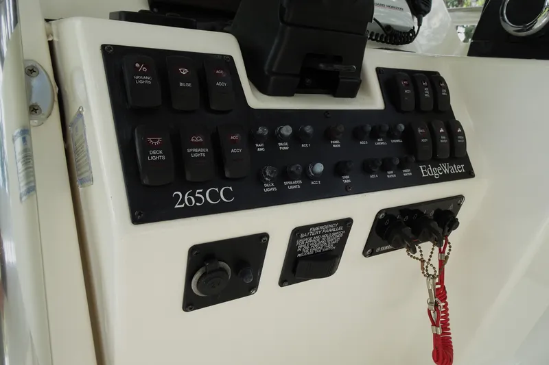 Slide: The Image of Control panel of a 2006 Edgewater 265CC boat with various switches and labels. - 24