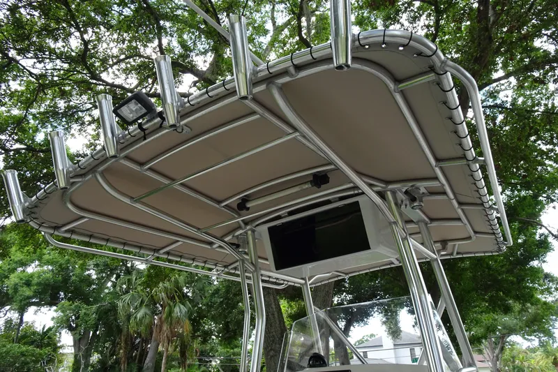 Slide: The Image of T-top of a 2006 Edgewater 265CC boat with rod holders and canopy. - 26