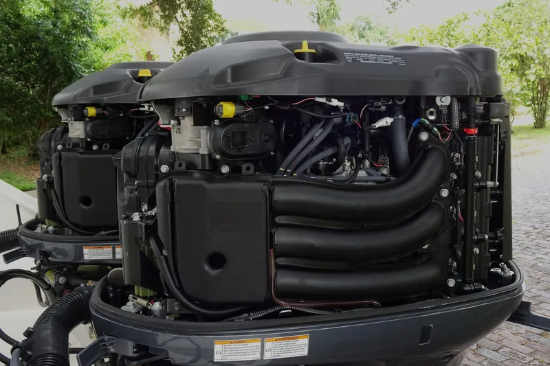 Slide: The Image of Twin outboard engines on a 2006 Edgewater 265CC boat, showcasing intricate mechanical details. - 30