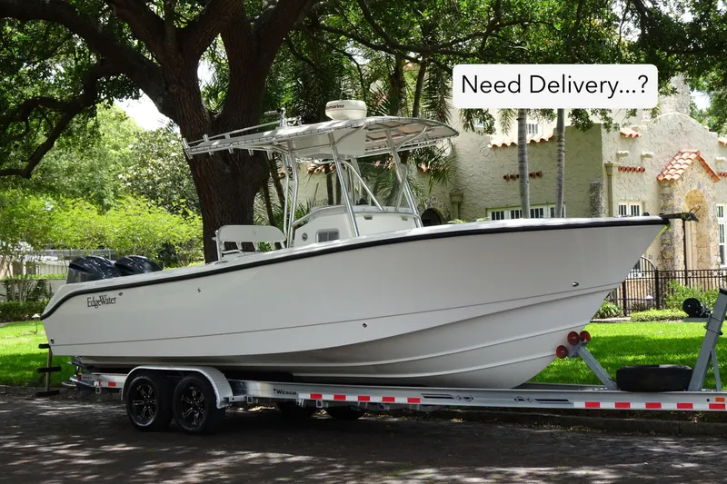 Slide: The Image of 2006 Edgewater 265CC boat on trailer, parked under trees, with "Need Delivery...?" text. - 33