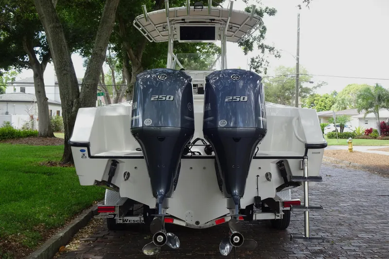 Slide: The Image of 2006 Edgewater 265CC boat with dual Yamaha 250 outboard engines, parked on a brick driveway. - 8