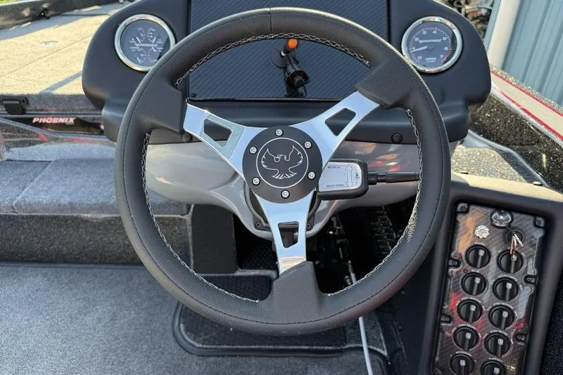 Slide: The Image of Steering wheel of 2026 Phoenix 818 Pro boat, featuring sleek design and control panel. - 12