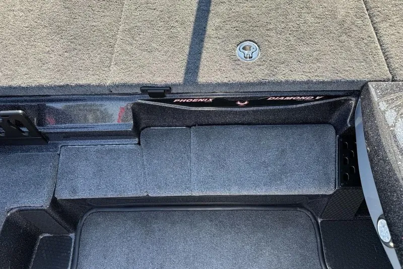 Slide: The Image of Interior view of 2026 Phoenix 818 Pro boat, featuring carpeted storage compartments. - 14