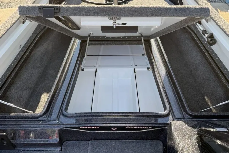 Slide: The Image of Open storage compartment of 2026 Phoenix 818 Pro boat, showcasing spacious interior design. - 15