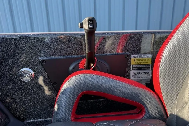 Slide: The Image of Boat interior with control lever, red and gray seat, and capacity warning label. Phoenix 818 Pro 2026. - 18