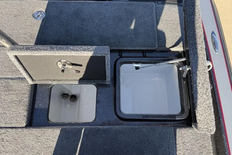 Slide: The Image of 2026 Phoenix 818 Pro boat storage compartments with open lids, showcasing interior design. - 19