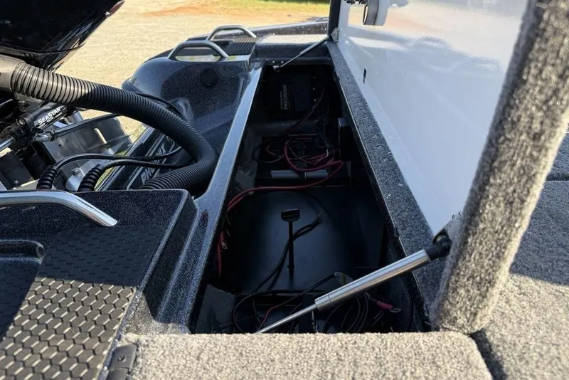 Slide: The Image of Open storage compartment of 2026 Phoenix 818 Pro boat, showing internal wiring and components. - 21