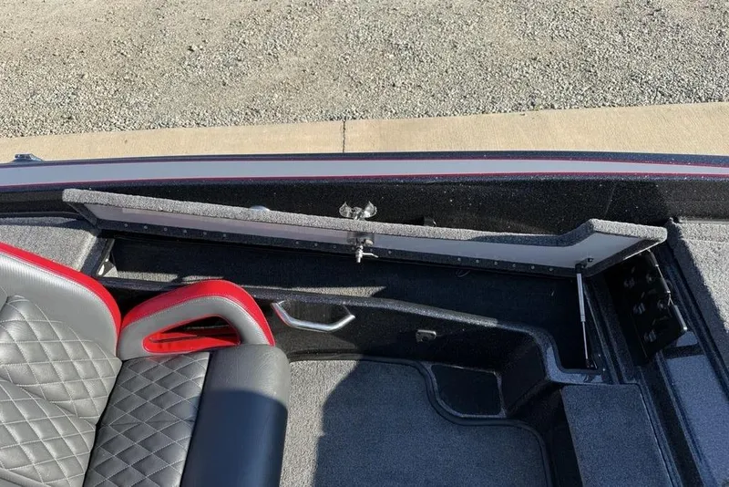 Slide: The Image of Interior of 2026 Phoenix 818 Pro boat with open storage compartment and quilted seat. - 24