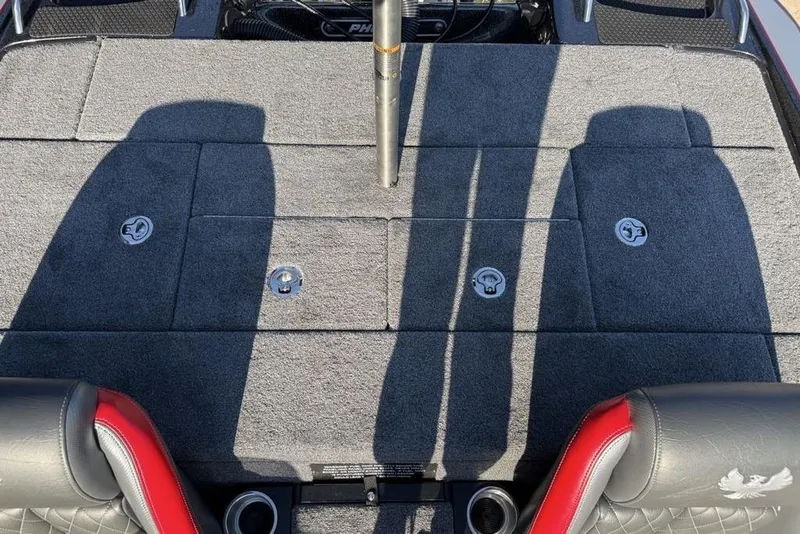 Slide: The Image of 2026 Phoenix 818 Pro boat interior with gray carpet and storage compartments. - 26