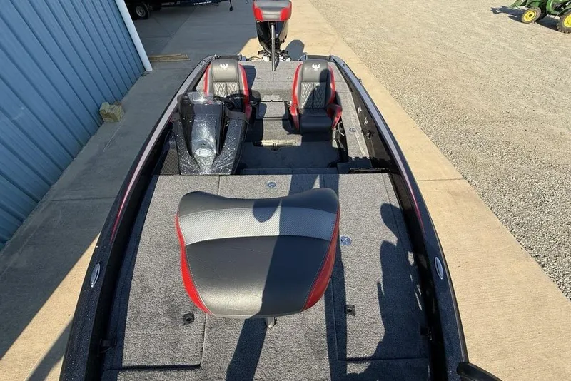 Slide: The Image of 2026 Phoenix 818 Pro boat interior with gray and red seating, docked on concrete. - 27