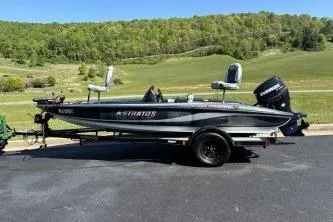 The Image of 2006 Stratos 275 Pro XL boat on trailer, parked outdoors with scenic background. - 1