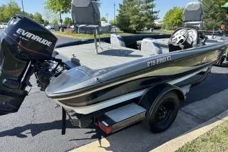 Slide: The Image of 2006 Stratos 275 Pro XL boat with Evinrude motor, parked outdoors. - 10
