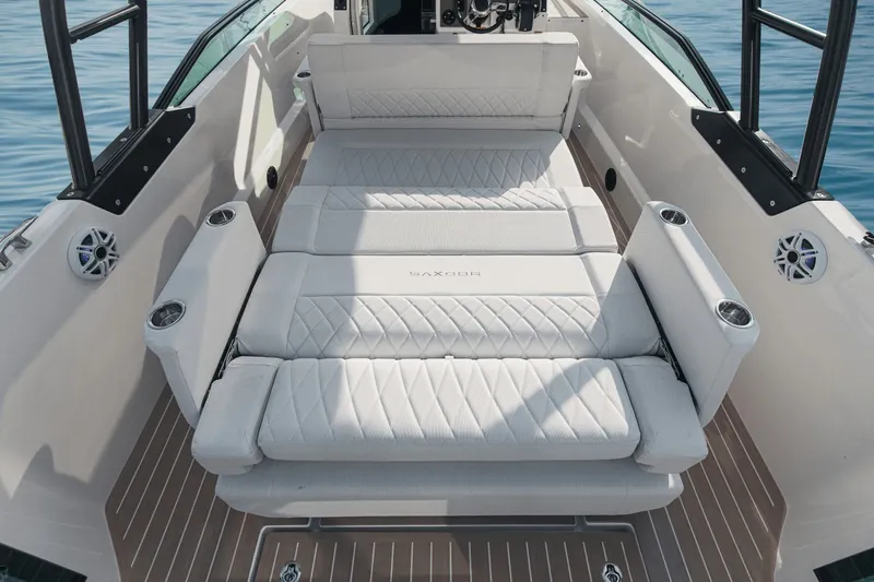 Slide: The Image of The image shows the deck of a Saxdor 270 GTO with white cushions and cup holders. - 9