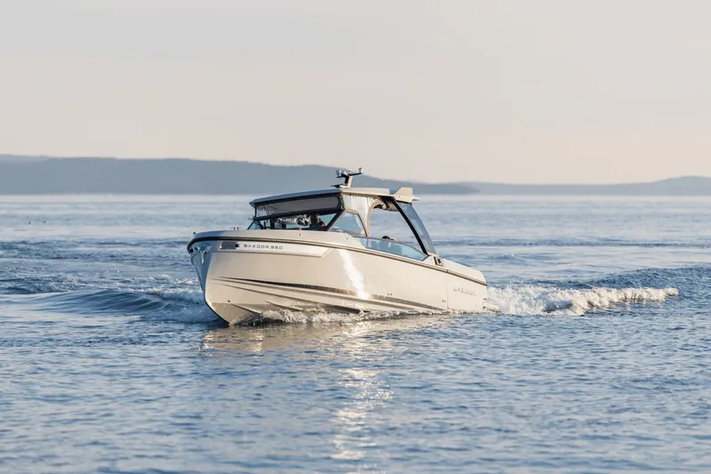 Slide: The Image of A 2027 Saxdor 320 GTO cruising on calm water with gentle waves. - 46