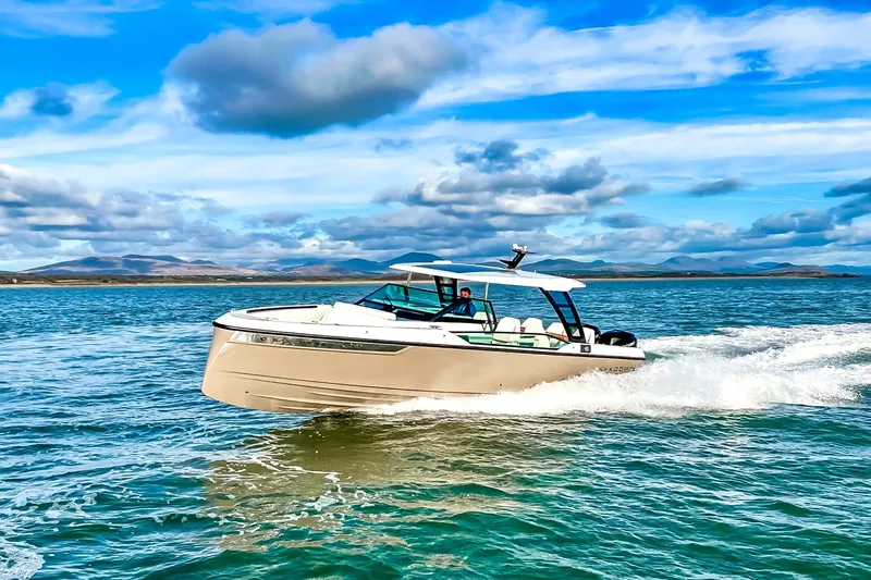 Slide: The Image of A 2027 Saxdor 320 GTO speeds across the water under a blue sky. - 24