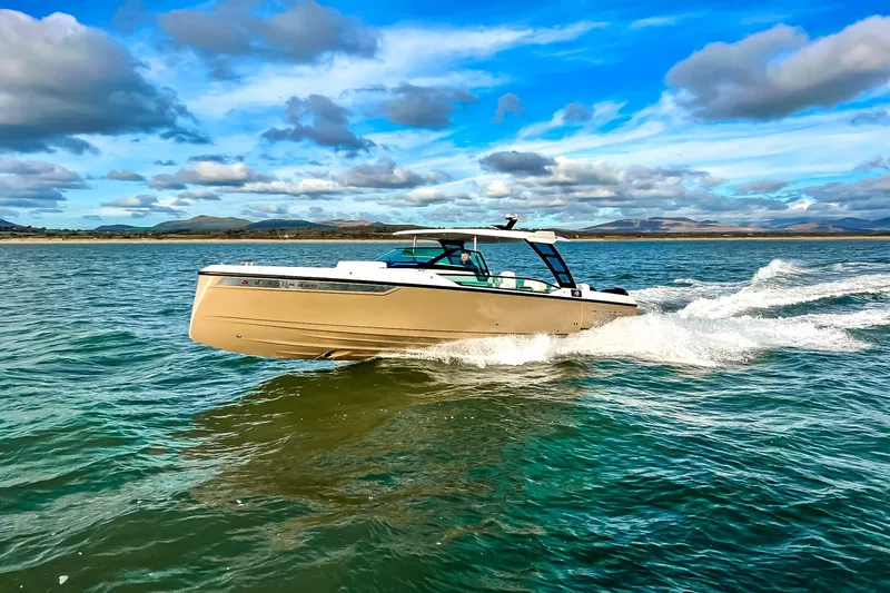 Slide: The Image of A 2027 Saxdor 320 GTO speeds across the water under a blue sky. - 21