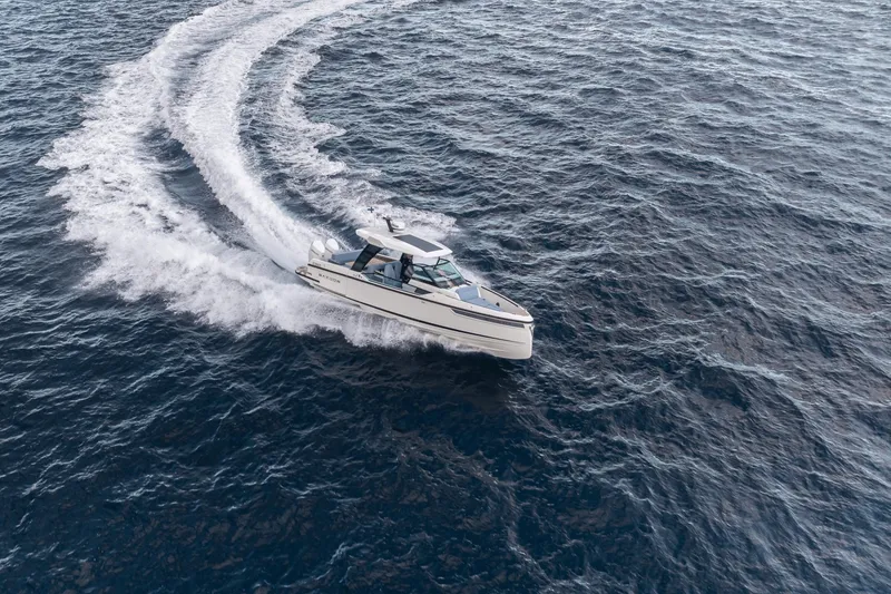 Slide: The Image of A 2027 Saxdor 320 GTO speeds across open water, leaving a trail of white wake. - 1
