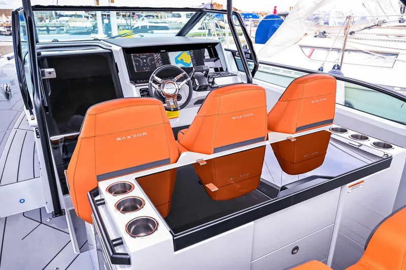Slide: The Image of The image shows the cockpit of a Saxdor 320 GTO with three orange seats and a modern helm. - 11
