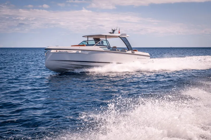 Slide: The Image of A 2027 Saxdor 320 GTO speeds across the blue sea under a clear sky. - 32