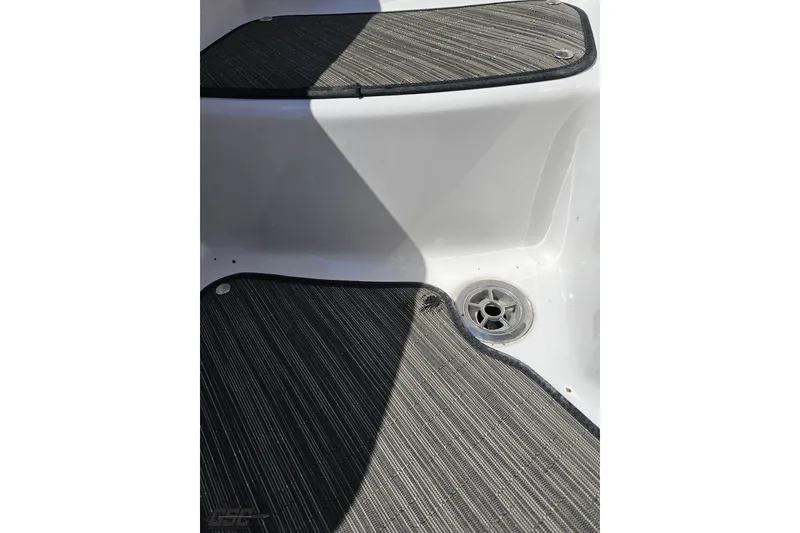 Slide: The Image of 2018 Four Winns HD220 boat interior with textured flooring and drainage. - 100
